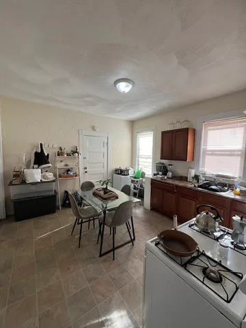 a living room with furniture a flat screen tv and a window