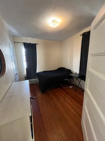 a bedroom with a bed and a mirror