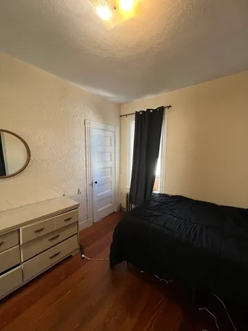 a bedroom with a bed and a potted plant