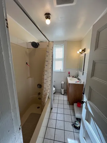 a bathroom with a sink mirror toilet shower and bathtub