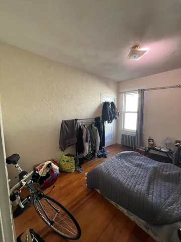 a bedroom with double bed and a window