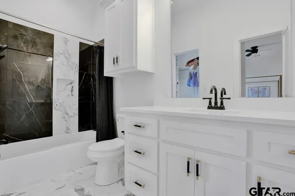 a view of an empty room with glass door and a window