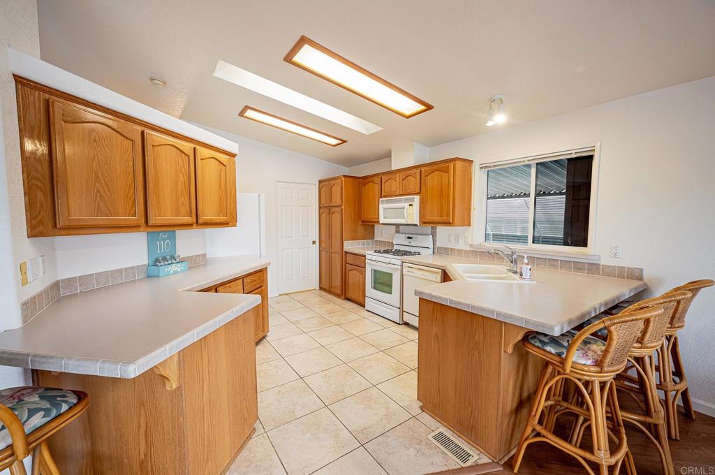 4650 Dulin Road, Unit 110 Fallbrook, CA 92003 - Photo 11 of 54 a kitchen with a sink a stove a refrigerator and cabinets