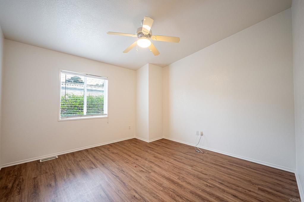 4650 Dulin Road, Unit 110 Fallbrook, CA 92003 - Photo 19 of 54 an empty room with wooden floor and windows
