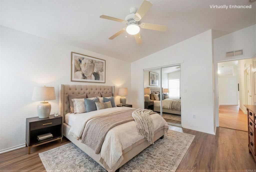 4650 Dulin Road, Unit 110 Fallbrook, CA 92003 - Photo 23 of 54 a bedroom with a bed and a chandelier