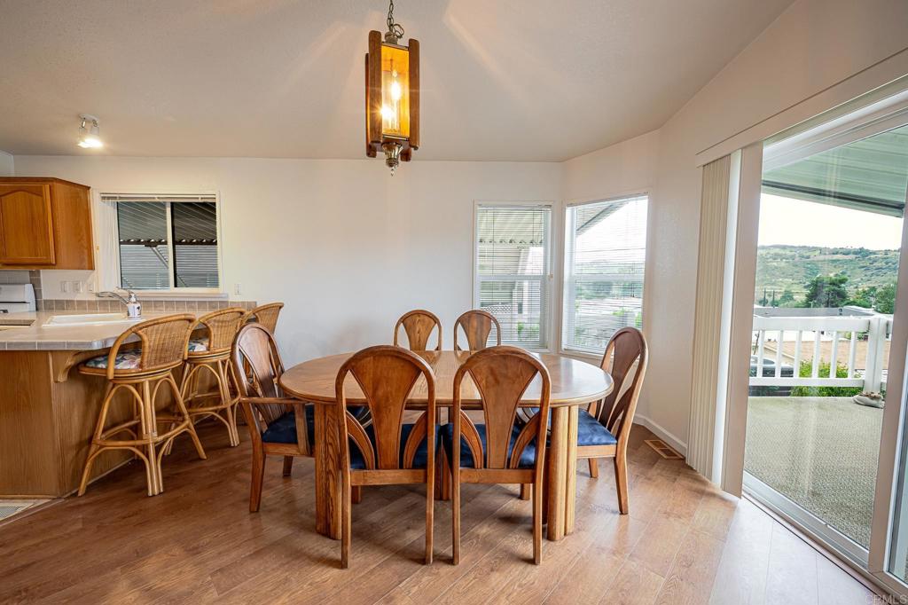 4650 Dulin Road, Unit 110 Fallbrook, CA 92003 - Photo 8 of 54 a view of a dining room with furniture and wooden floor