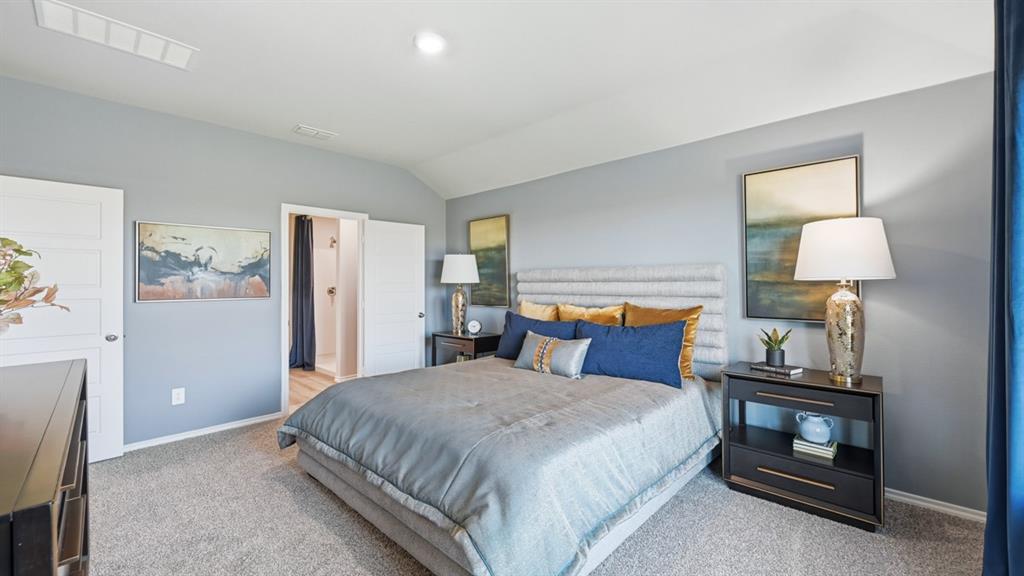 16536 Hudson Pr Way Justin, TX 76247 - Photo 15 of 39 a bedroom with a bed and a lamp on table