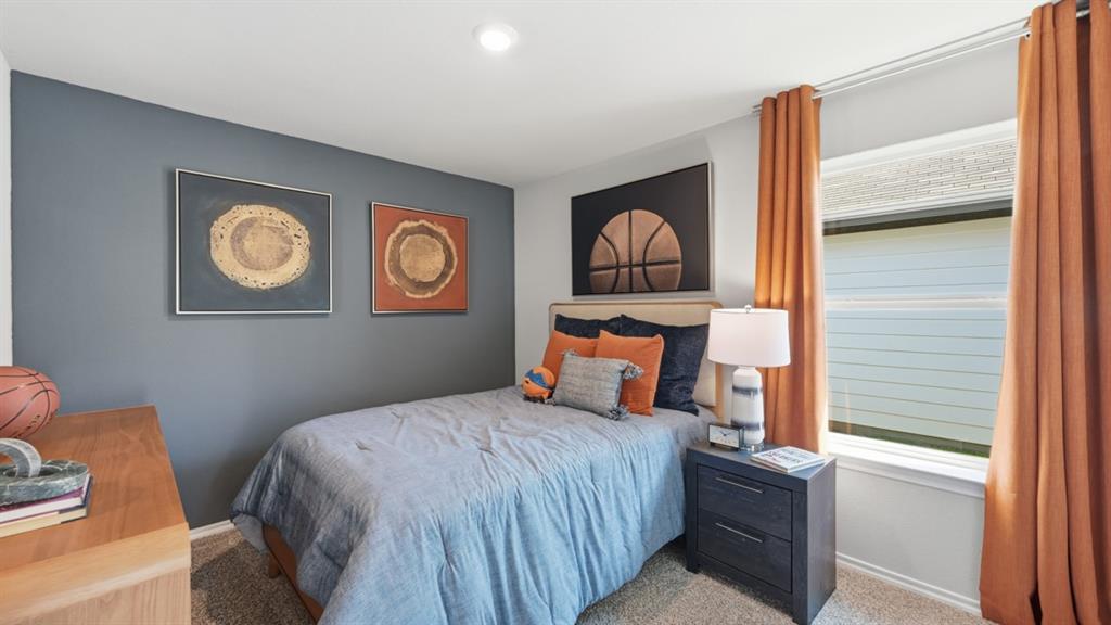 16536 Hudson Pr Way Justin, TX 76247 - Photo 22 of 39 a bedroom with a bed and a lamp next to a window