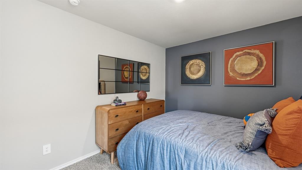 16536 Hudson Pr Way Justin, TX 76247 - Photo 25 of 39 a bedroom with a bed and a lamp on dresser