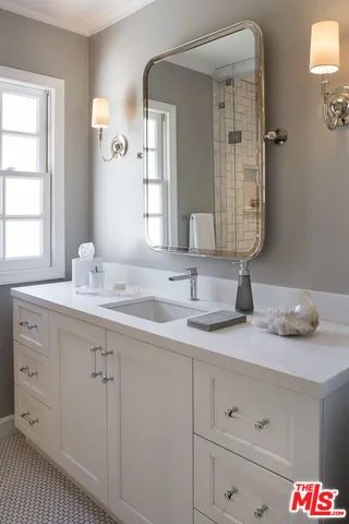 a bathroom with a sink and a mirror