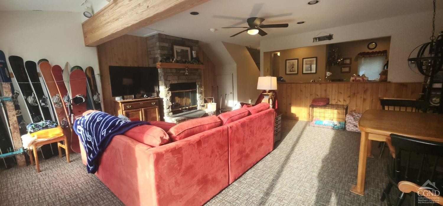63 Windham Ridge Road Windham, NY 12496 - Photo 20 of 21 a living room with furniture a flat screen tv and kitchen view