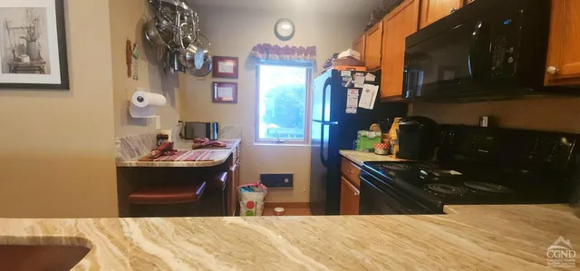a kitchen with kitchen island a stove and a sink