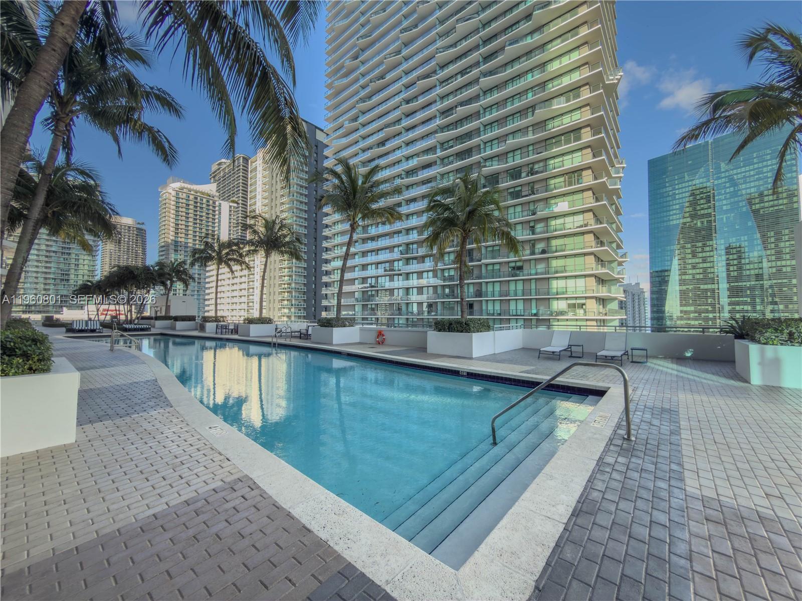 60 Southwest 13th Street, Unit 1605 Miami, FL 33130 - Photo 18 of 30 a view of swimming pool with outdoor seating