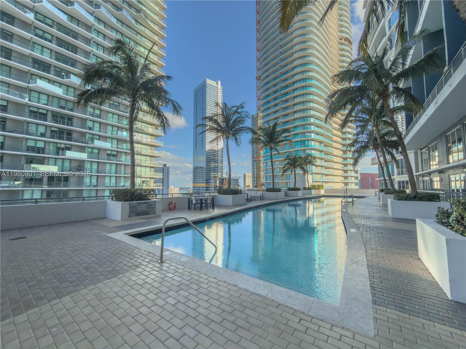60 Southwest 13th Street, Unit 1605 Miami, FL 33130 - Photo 19 of 30 a view of a swimming pool with a patio