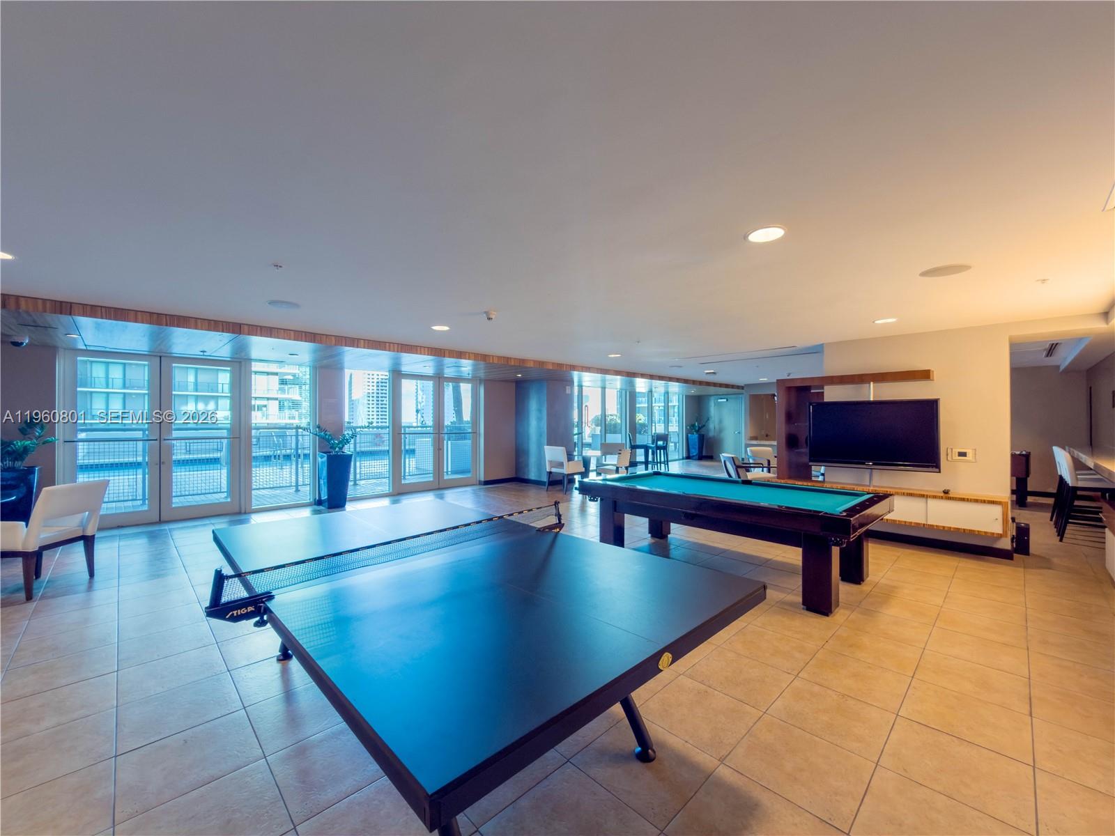 60 Southwest 13th Street, Unit 1605 Miami, FL 33130 - Photo 22 of 30 a living room with furniture a rug and a floor to ceiling window