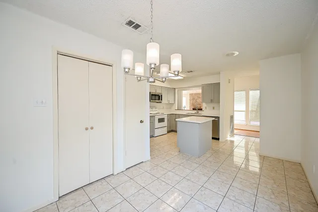 a kitchen with stainless steel appliances granite countertop a sink and a refrigerator