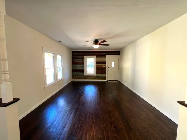 a view of wooden floor and windows in an empty room