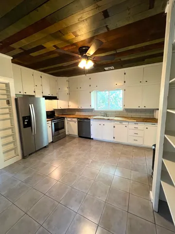 a kitchen with refrigerator and window