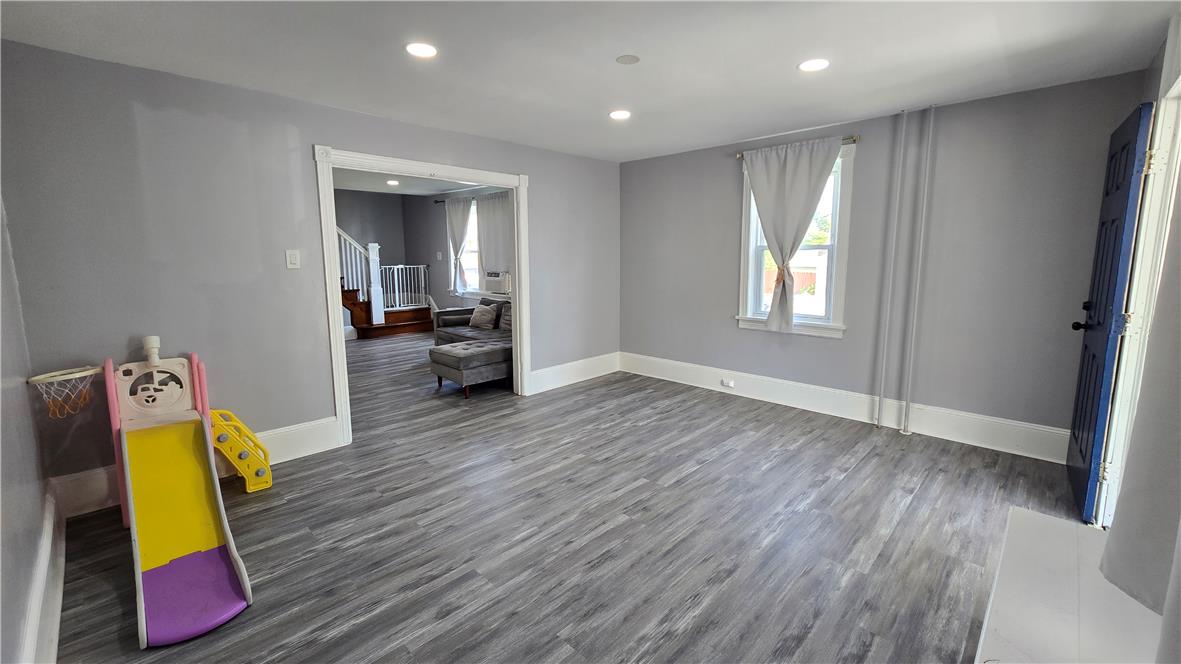 883 North Locust Street Hazleton, PA 18201 - Photo 11 of 83 Laminated flooring and high ceilings characterize this well-lit living space.