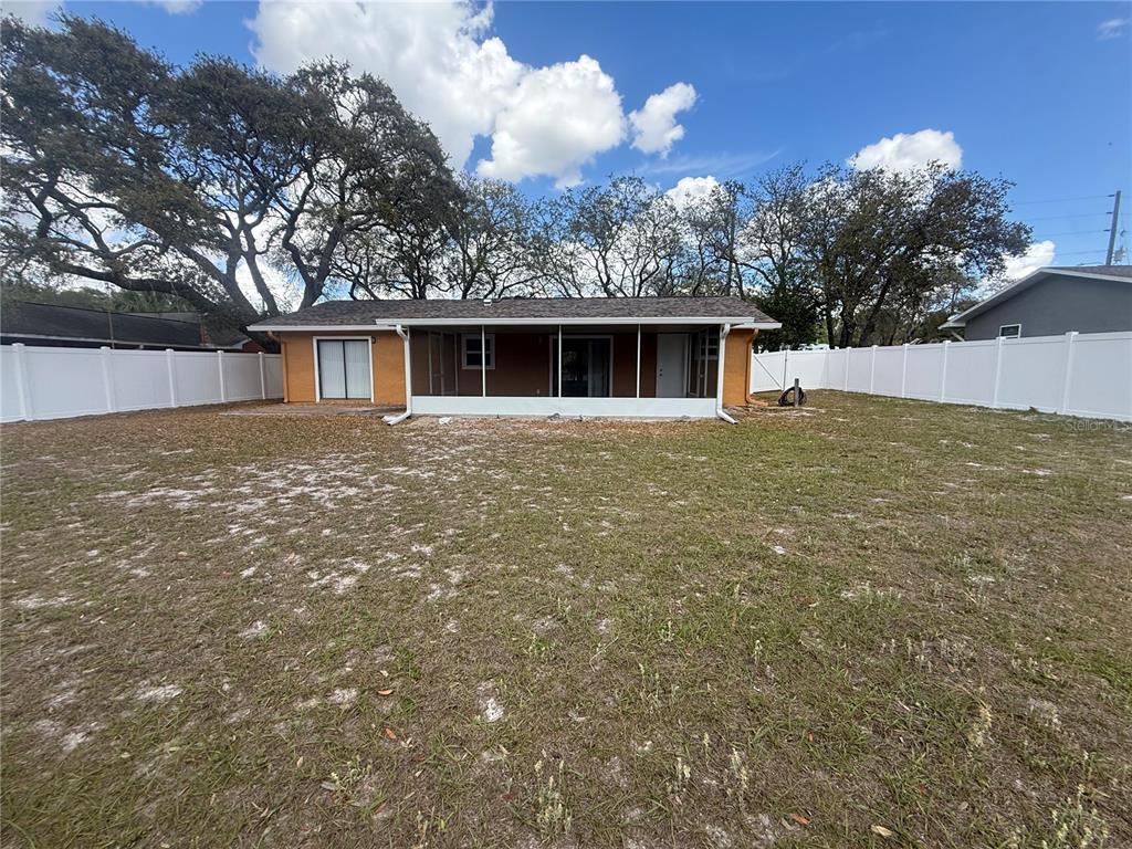7350 Landmark Drive Spring Hill, FL 34606 - Photo 14 of 16 front view of house with yard and trees all around