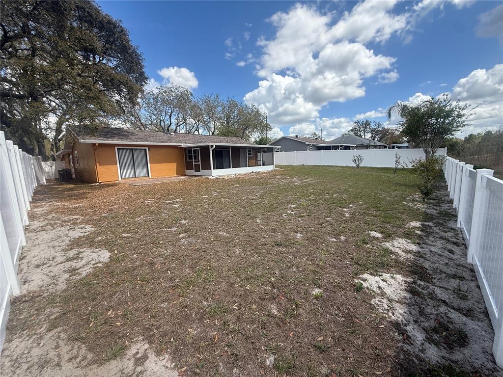 7350 Landmark Drive Spring Hill, FL 34606 - Photo 15 of 16 a view of house with backyard and garden