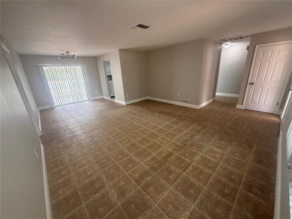 7350 Landmark Drive Spring Hill, FL 34606 - Photo 3 of 16 a view of an empty room with wooden floor and a window