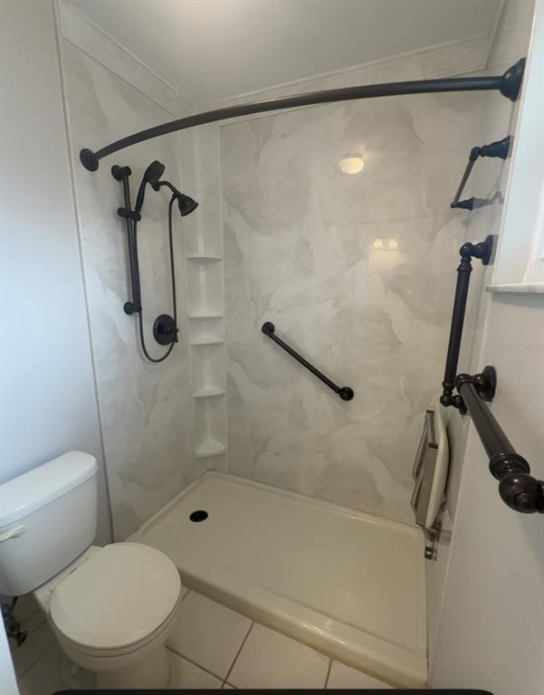 7350 Landmark Drive Spring Hill, FL 34606 - Photo 4 of 16 a bathroom with a shower and a toilet