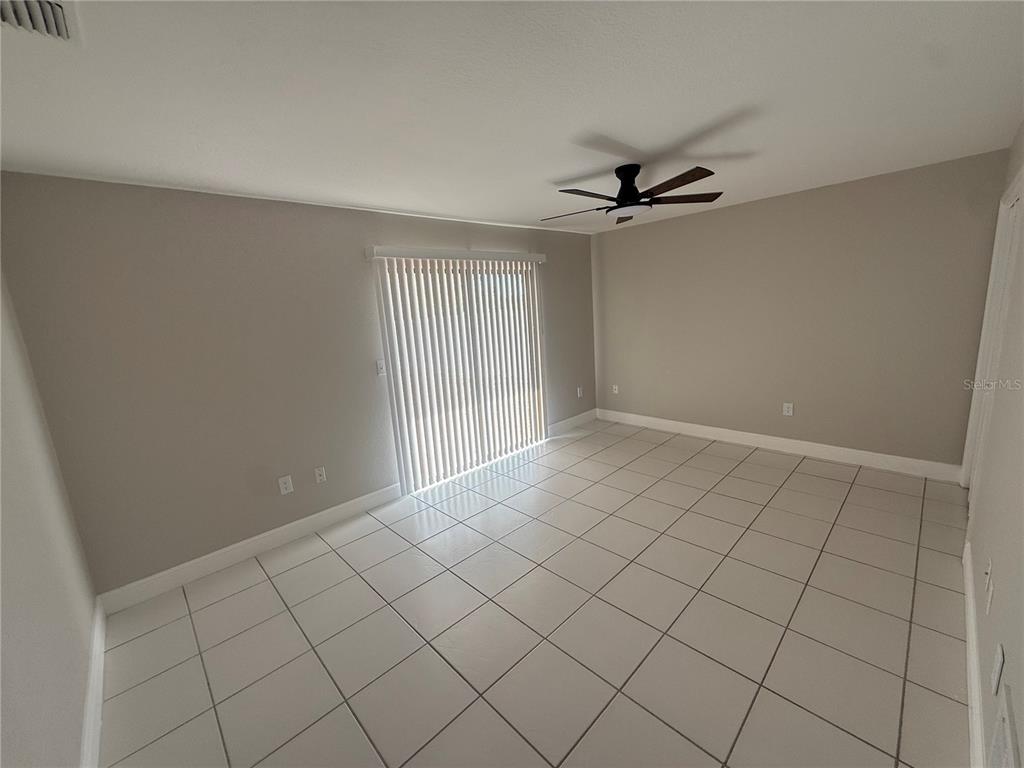 7350 Landmark Drive Spring Hill, FL 34606 - Photo 7 of 16 an empty room with windows