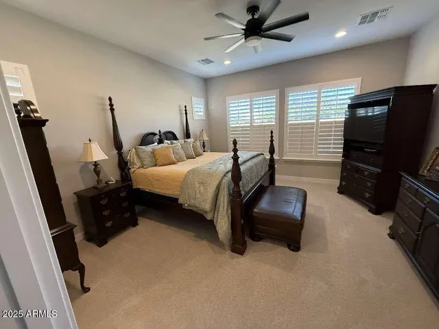 a bedroom with furniture and a flat screen tv