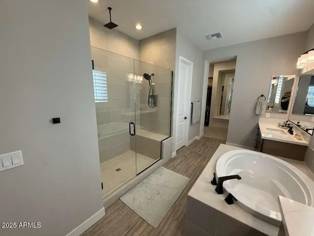a bathroom with a shower sink and mirror
