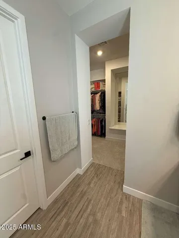 a view of hallway with wooden floor and stairs