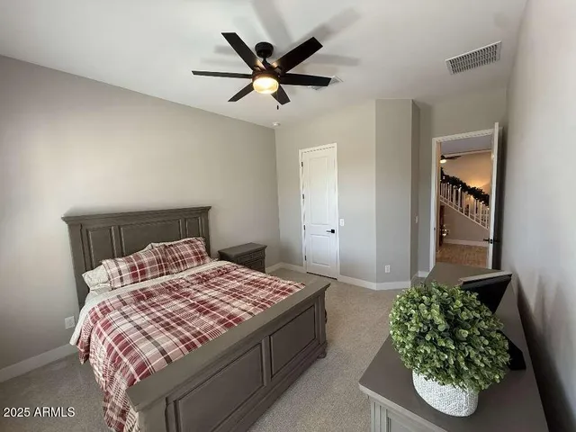 a bedroom with a bed and a potted plant