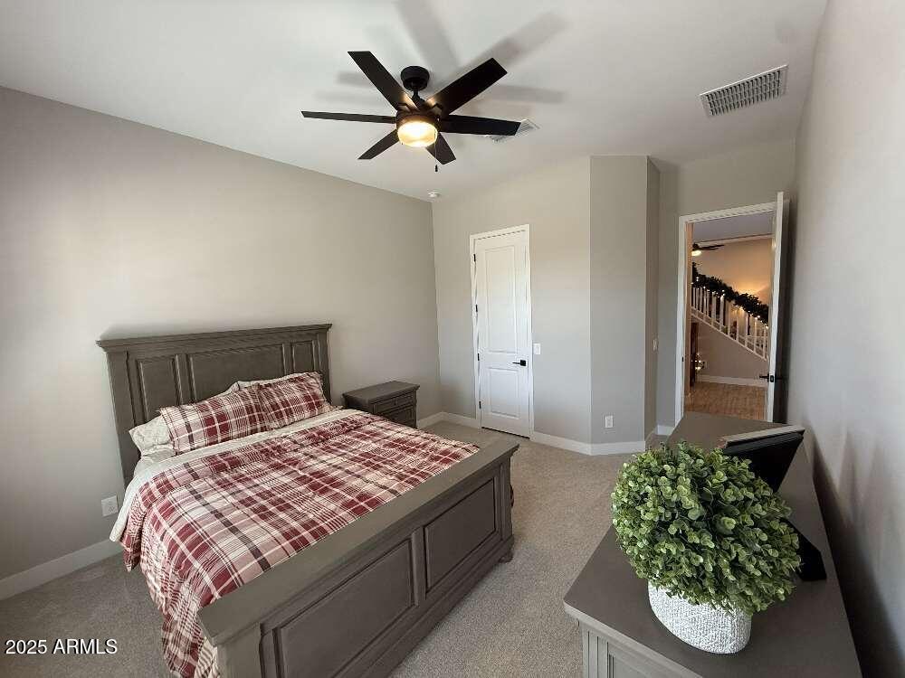 1932 West Rowel Road Phoenix, AZ 85085 - Photo 17 of 24 a bedroom with a bed and a potted plant