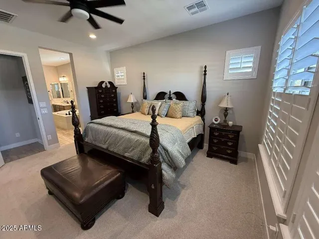 a bedroom with a bed couch and a window