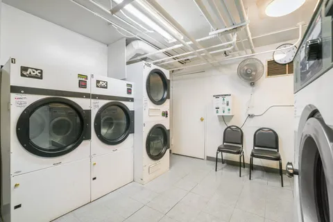 a view of a storage & utility room with dryer and washer