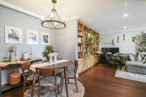 a view of a dining room with furniture window and wooden floor