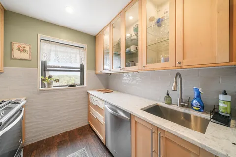 a view of a kitchen with a sink a microwave and cabinets