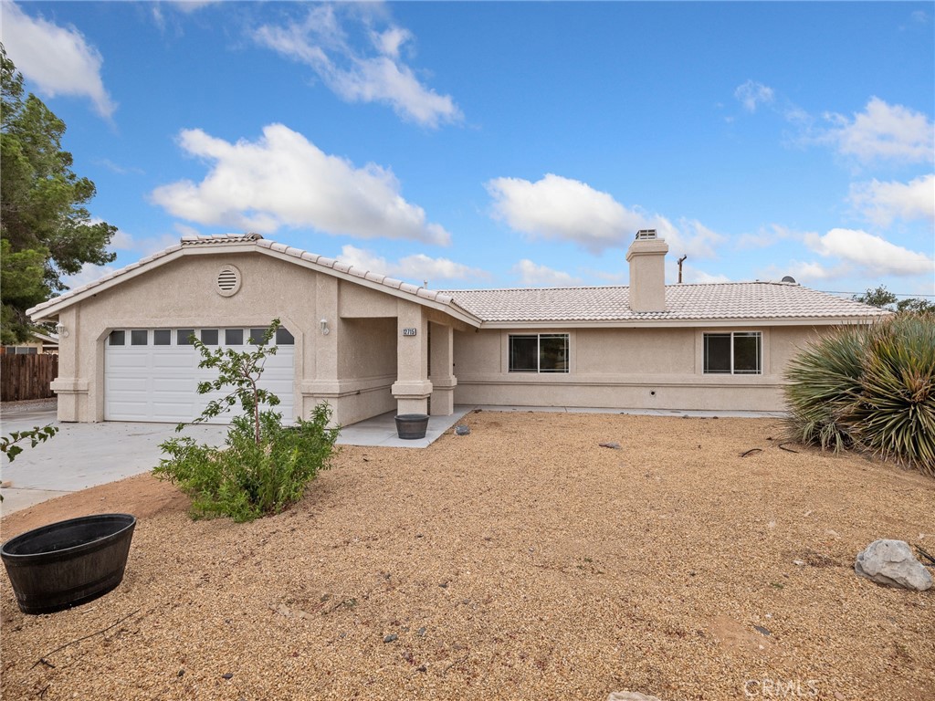 12715 Tesuque Road Apple Valley, CA 92308 - Photo 1 of 1 a front view of a house with a yard