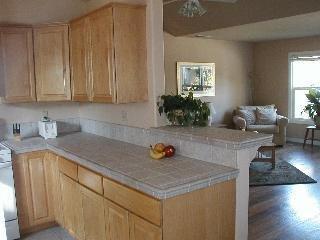 1831 Beaver Street Santa Rosa, CA 95404 - Photo 4 of 10 a kitchen with stainless steel appliances granite countertop a sink dishwasher stove and cabinets with wooden floor