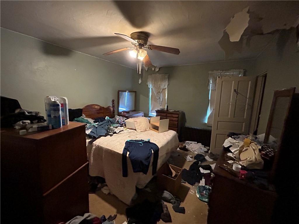 311 Magazine Street Carnegie, PA 15106 - Photo 12 of 16 a bed room with a bed mirror and a ceiling fan