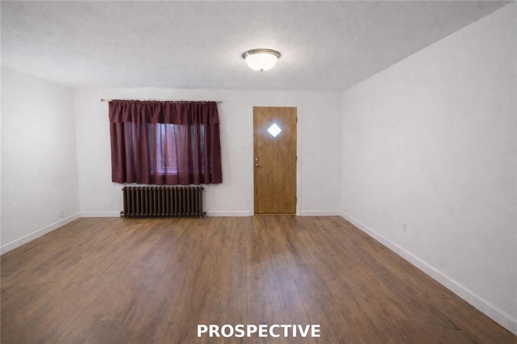 311 Magazine Street Carnegie, PA 15106 - Photo 3 of 16 an empty room with wooden floor and windows