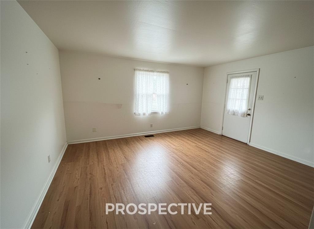 311 Magazine Street Carnegie, PA 15106 - Photo 6 of 16 an empty room with wooden floor and windows
