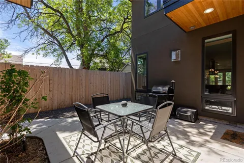 a view of a patio with table and chairs and potted plants
