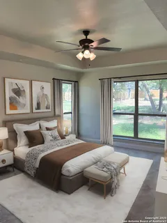 a bedroom with a large bed and a large window