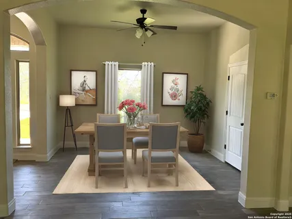 a dining room with wooden floor a chandelier a wooden table and chairs