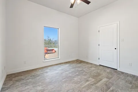 an empty room with windows and closet