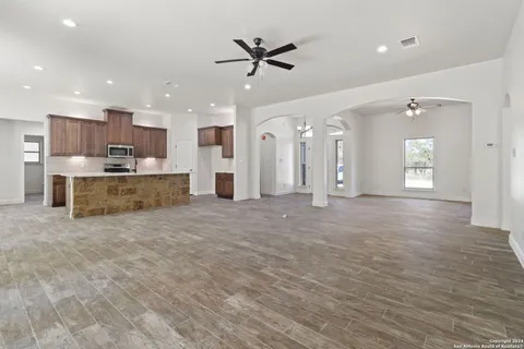 a view of a kitchen with a sink and a stove top oven