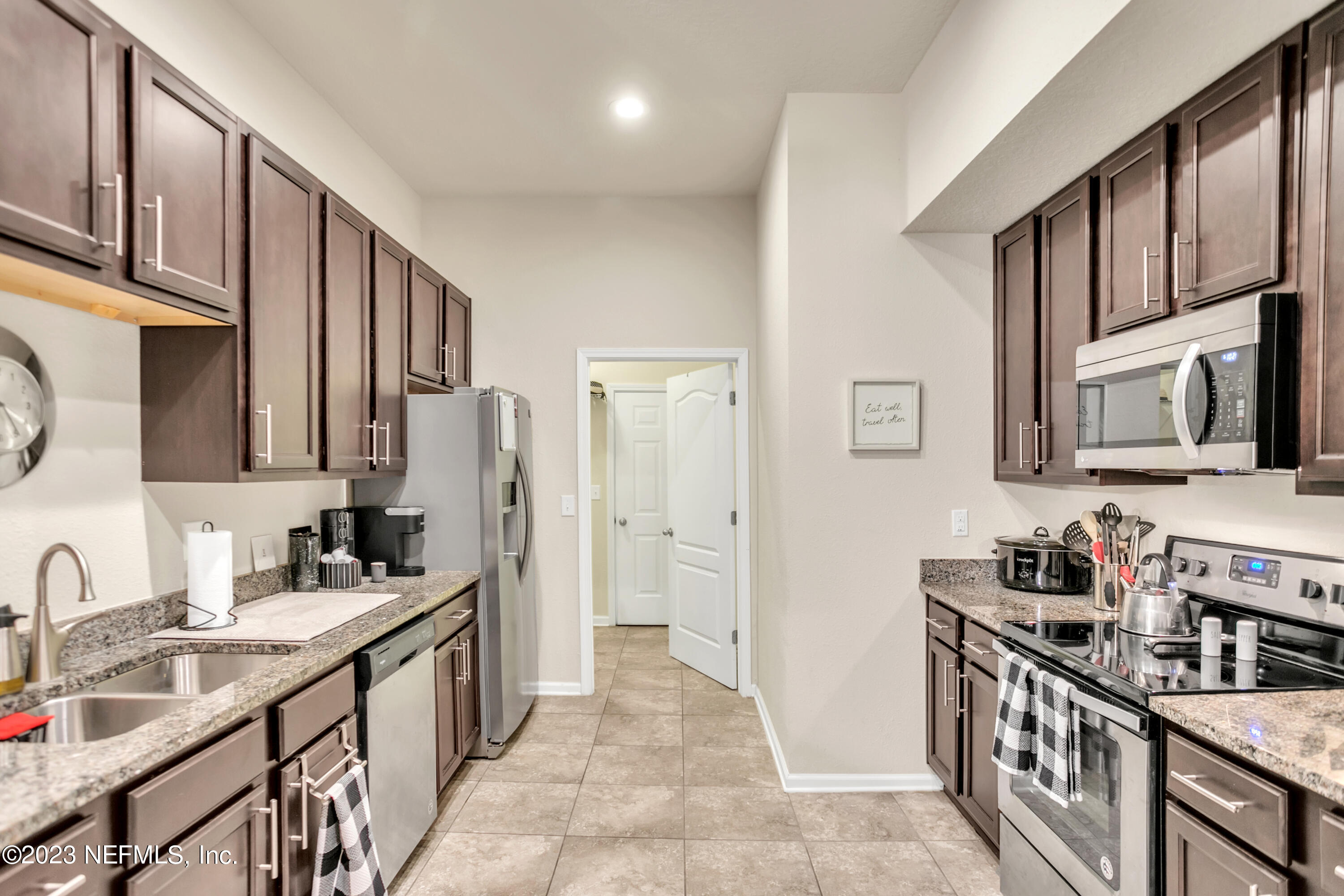 200 Larkin Place, Unit 101 St. Johns, FL 32259 - Photo 1 of 29 a kitchen with stainless steel appliances granite countertop a sink stove and cabinets