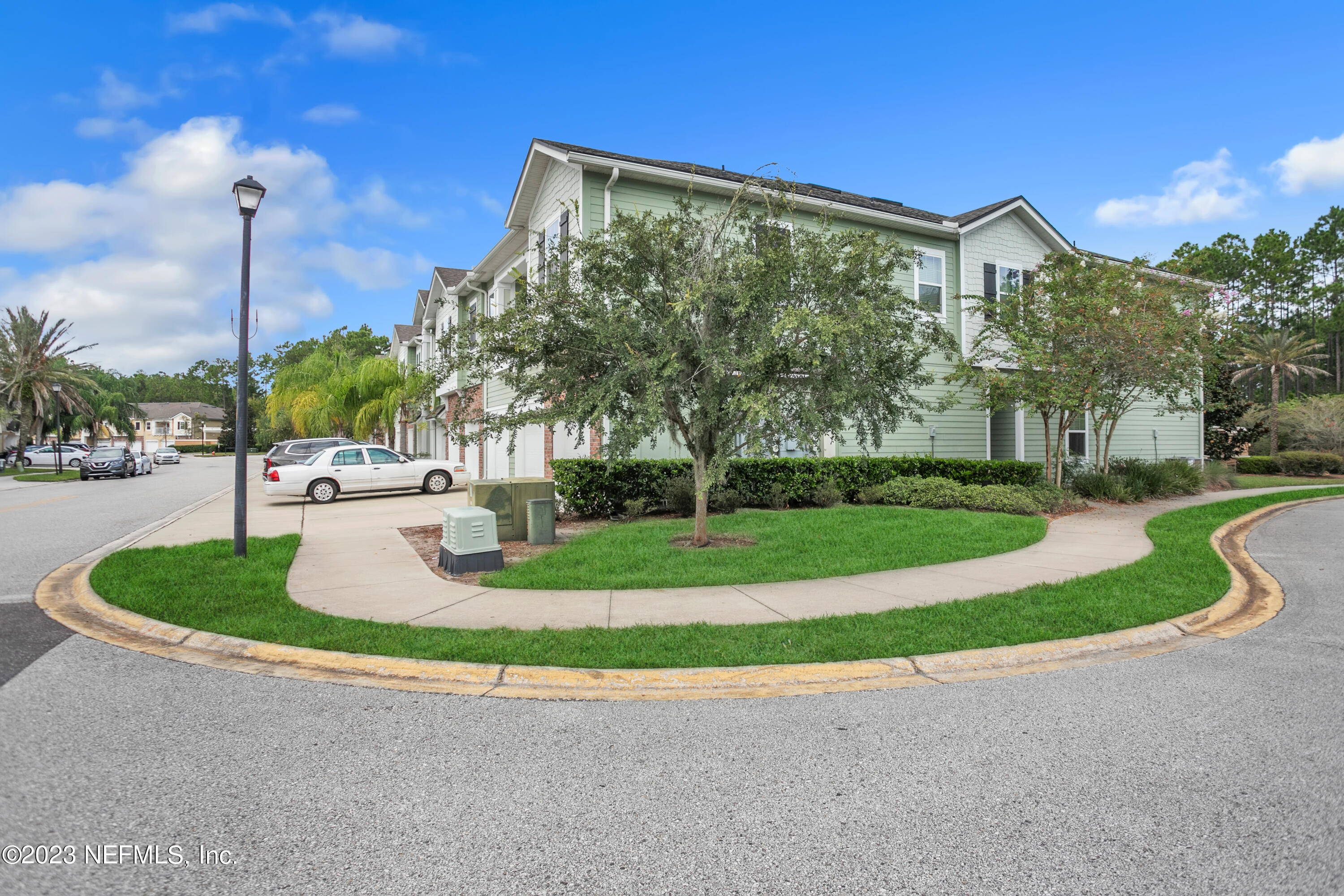 200 Larkin Place, Unit 101 St. Johns, FL 32259 - Photo 18 of 29 a front view of a house with a yard and garage