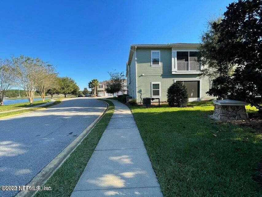 200 Larkin Place, Unit 101 St. Johns, FL 32259 - Photo 20 of 29 a front view of a house with a yard and garage
